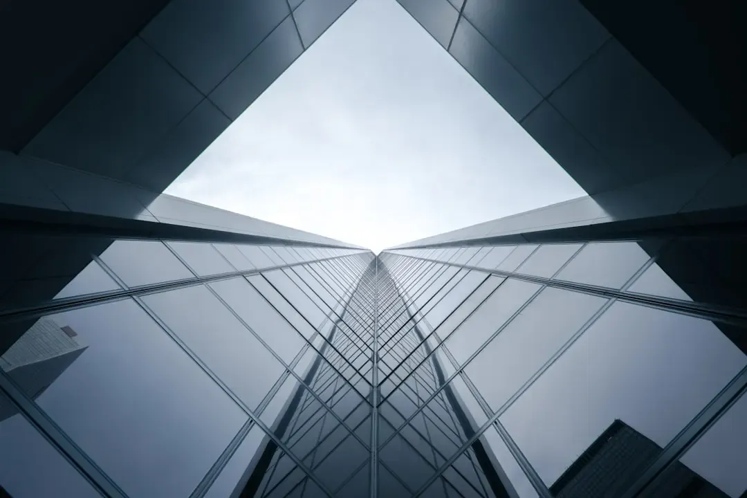 A modern building seen from below, in black and white